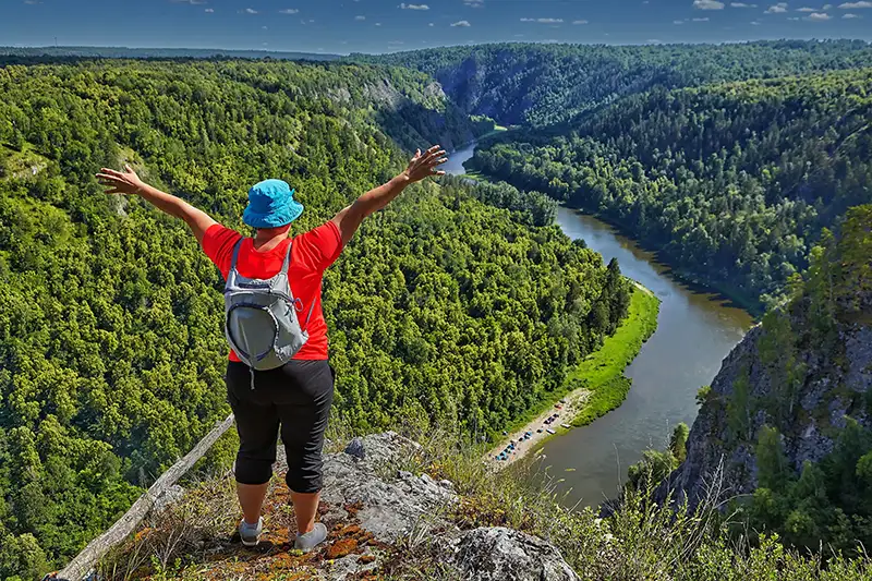hiker looking at a river