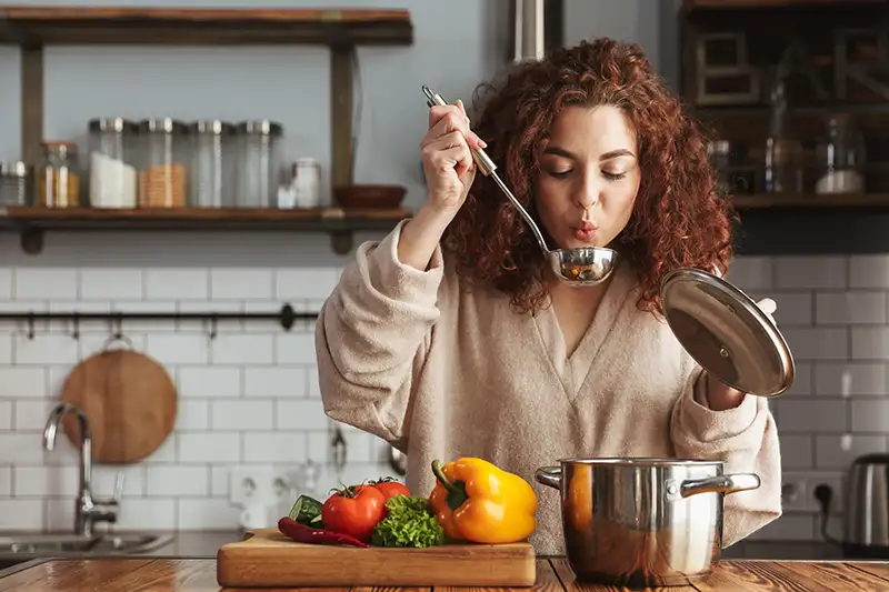 woman cooking soup
