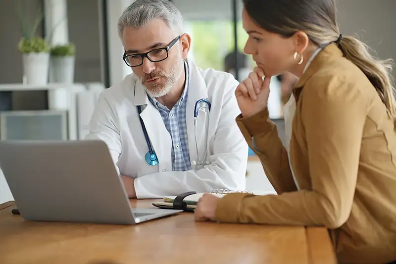 doctor and patient looking at computer