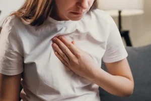 woman holding chest